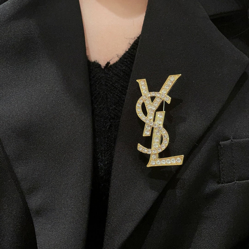 YSL 26S CRYSTAL MONOGRAM BROOCH IN GOLD TONE METAL 631043