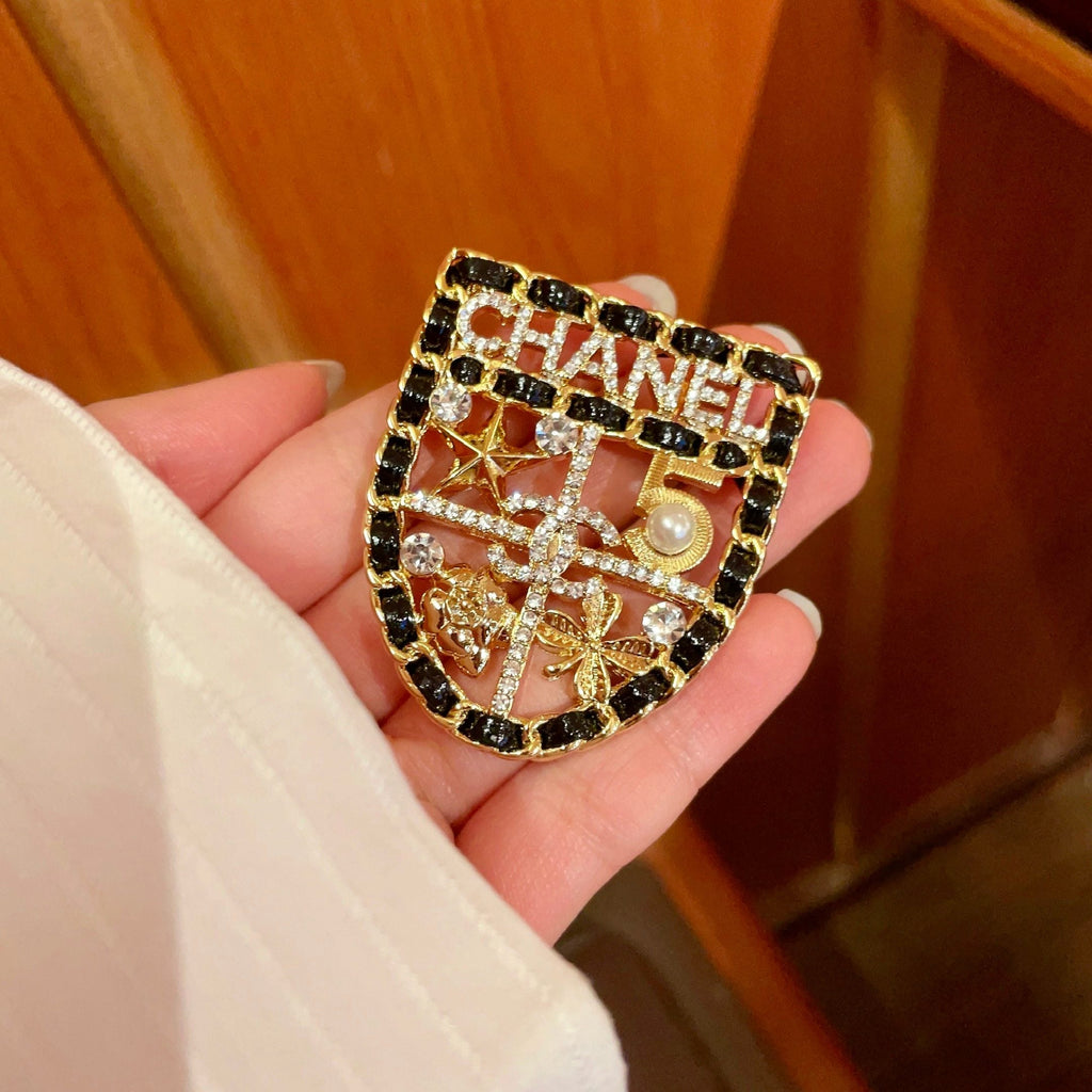 CHANEL 26S NUMBER SHIELD BROOCH WITH MULTI-CRYSTAL DETAIL IN GOLD METAL 631042