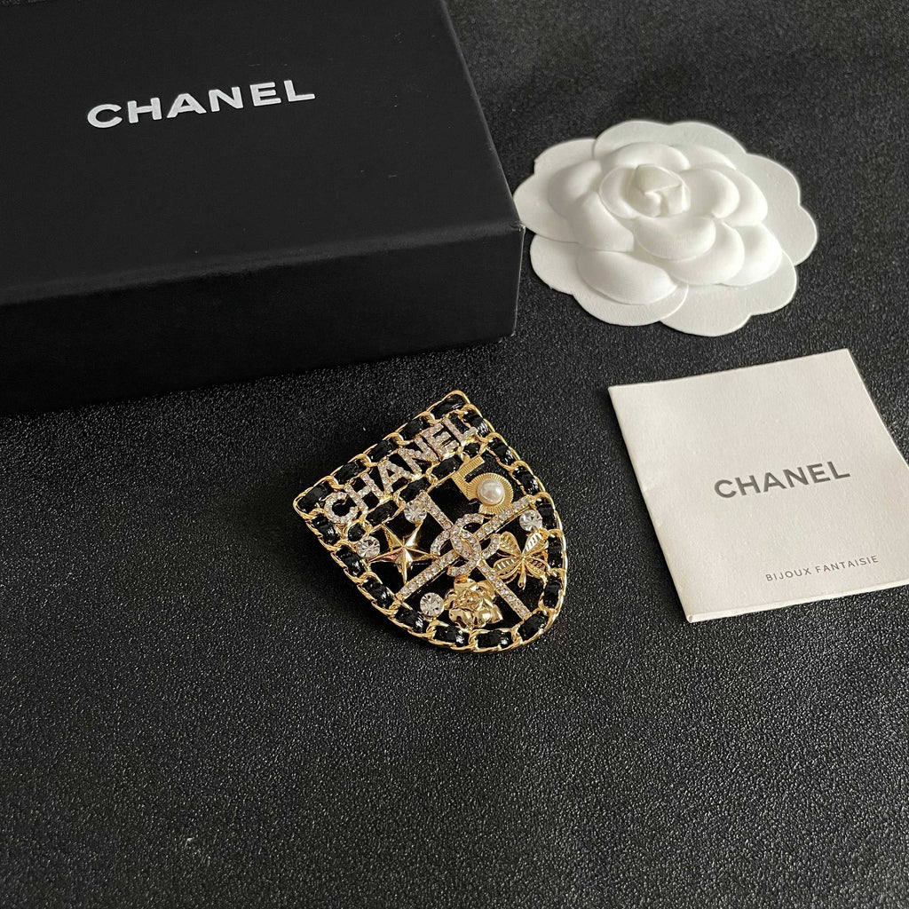 CHANEL 26S NUMBER SHIELD BROOCH WITH MULTI-CRYSTAL DETAIL IN GOLD METAL 631042