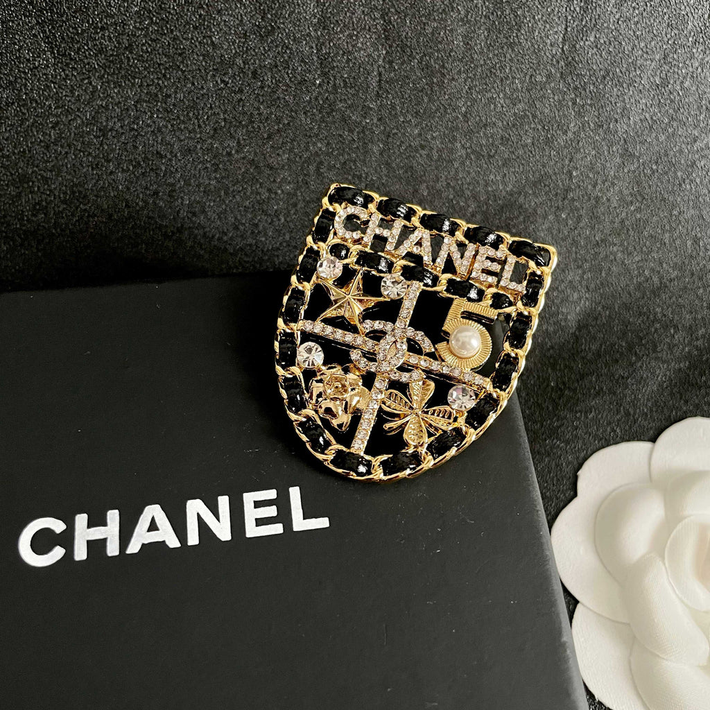 CHANEL 26S NUMBER SHIELD BROOCH WITH MULTI-CRYSTAL DETAIL IN GOLD METAL 631042