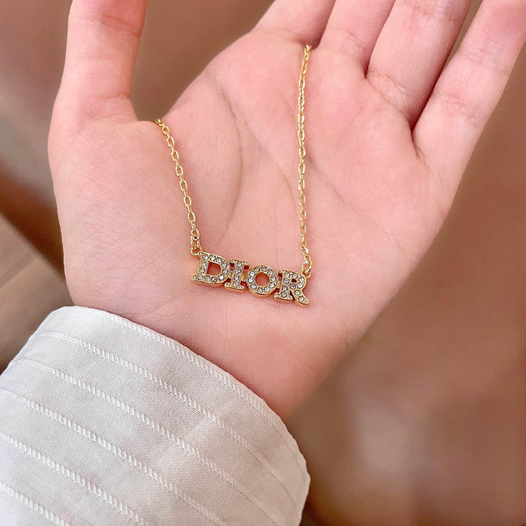 CD 26S PAVE LOGO LETTER NECKLACE IN GOLD TONE METAL 631806
