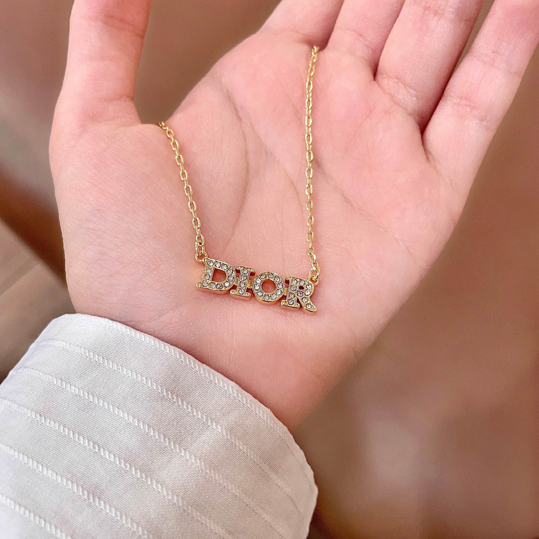 CD 26S PAVE LOGO LETTER NECKLACE IN GOLD TONE METAL 631806