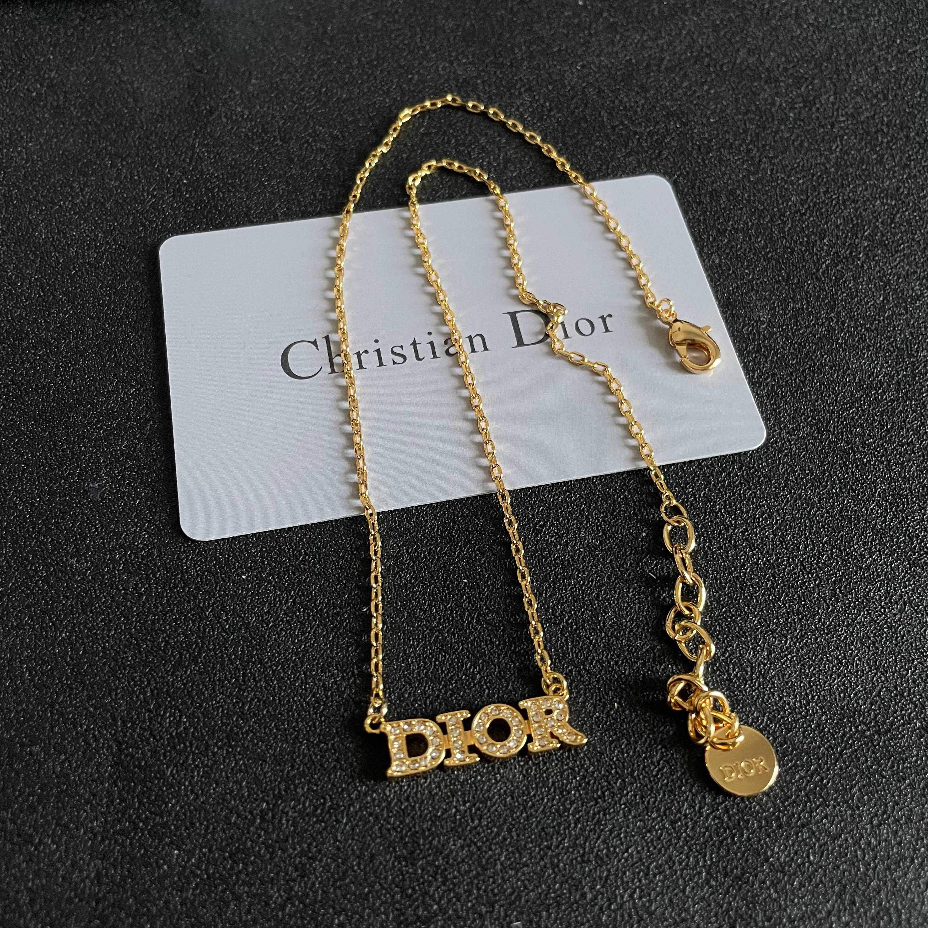 CD 26S PAVE LOGO LETTER NECKLACE IN GOLD TONE METAL 631806