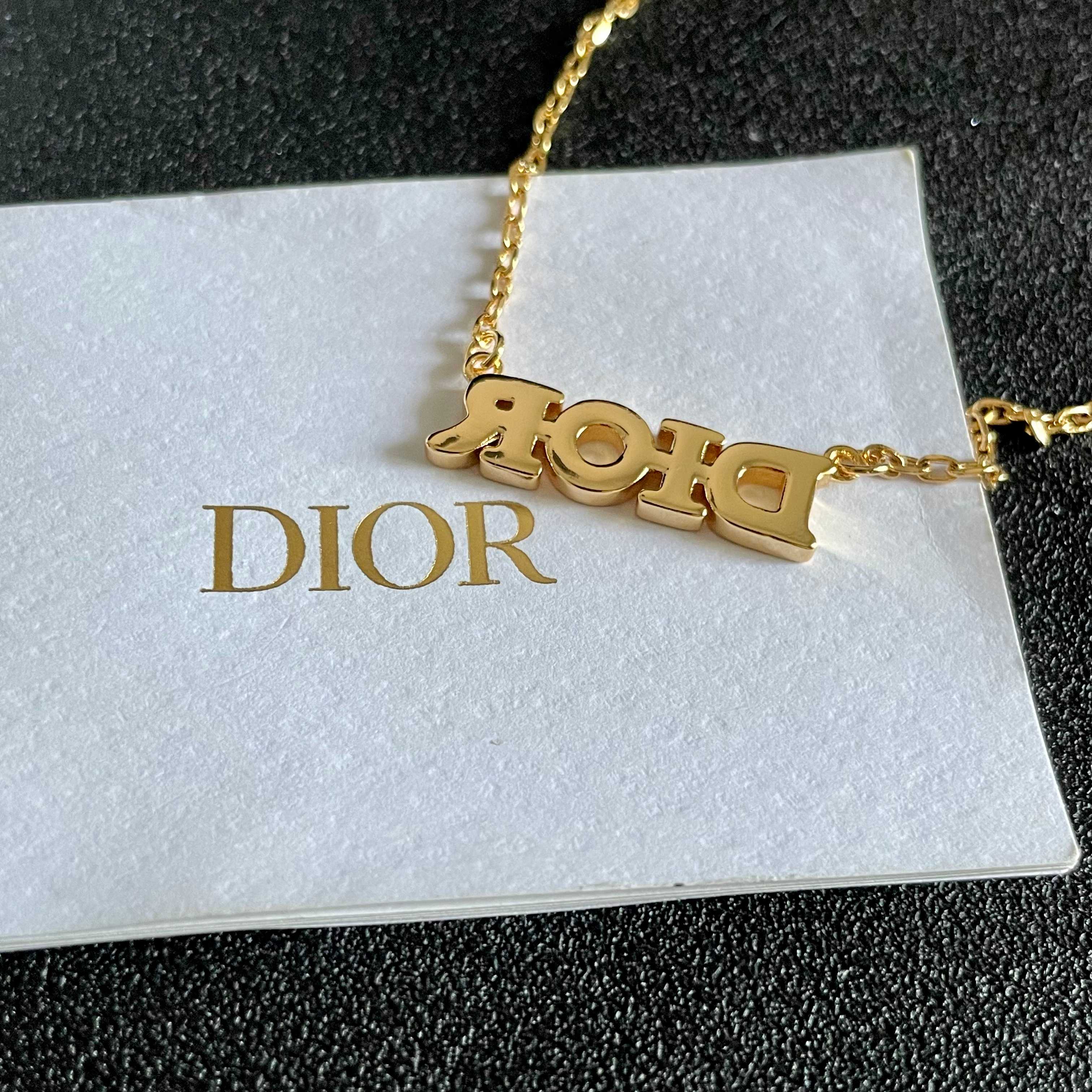 CD 26S PAVE LOGO LETTER NECKLACE IN GOLD TONE METAL 631806