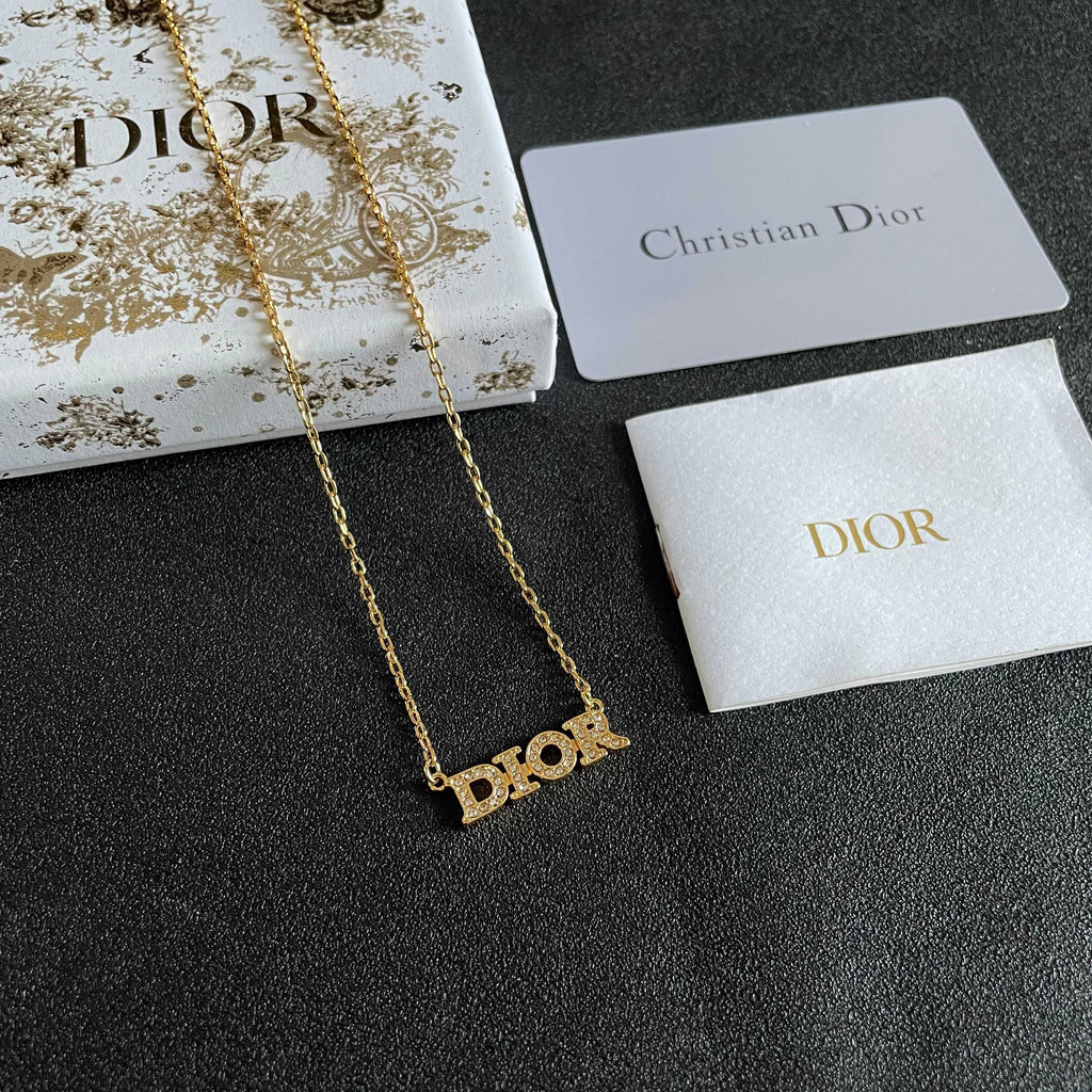 CD 26S PAVE LOGO LETTER NECKLACE IN GOLD TONE METAL 631806