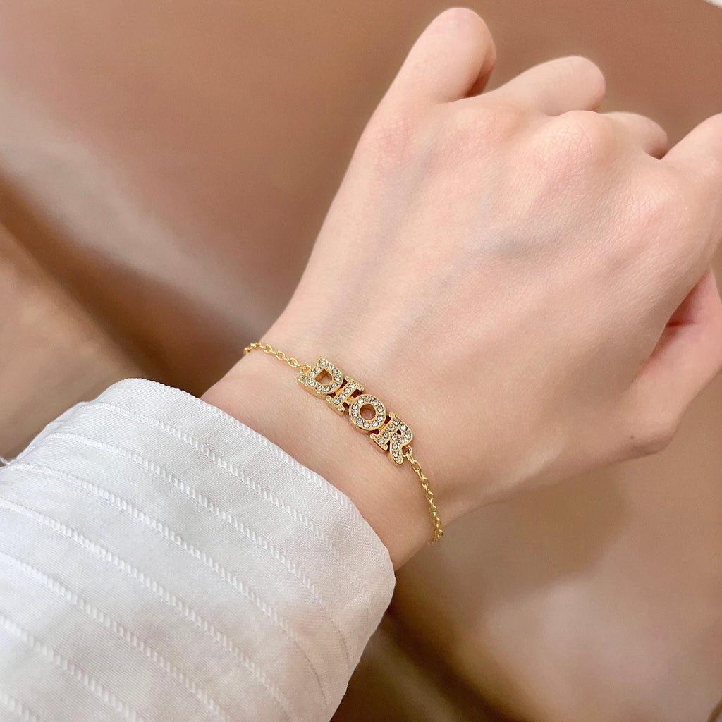 CD 26S PAVE LOGO LETTER BRACELET IN GOLD TONE METAL 631808