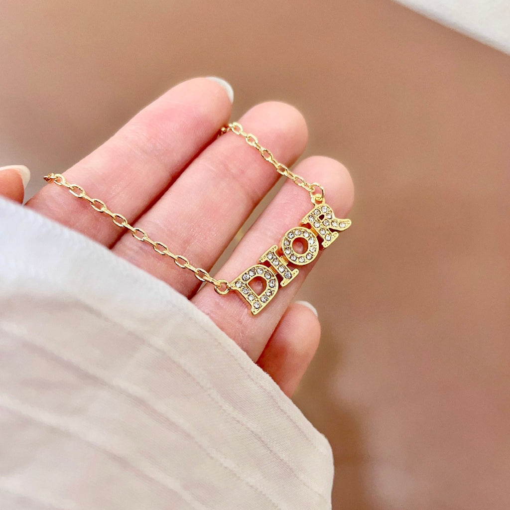 CD 26S PAVE LOGO LETTER BRACELET IN GOLD TONE METAL 631808