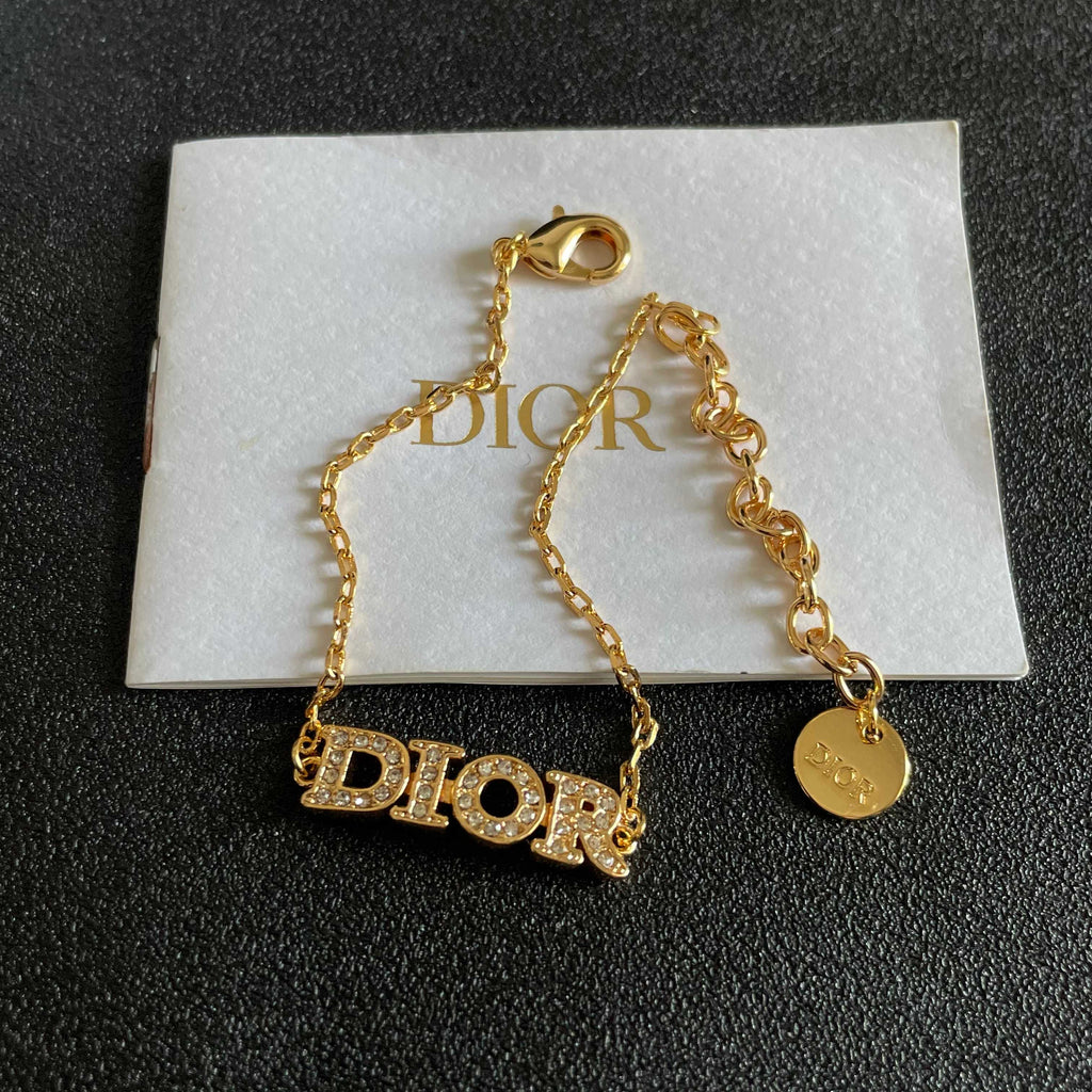 CD 26S PAVE LOGO LETTER BRACELET IN GOLD TONE METAL 631808