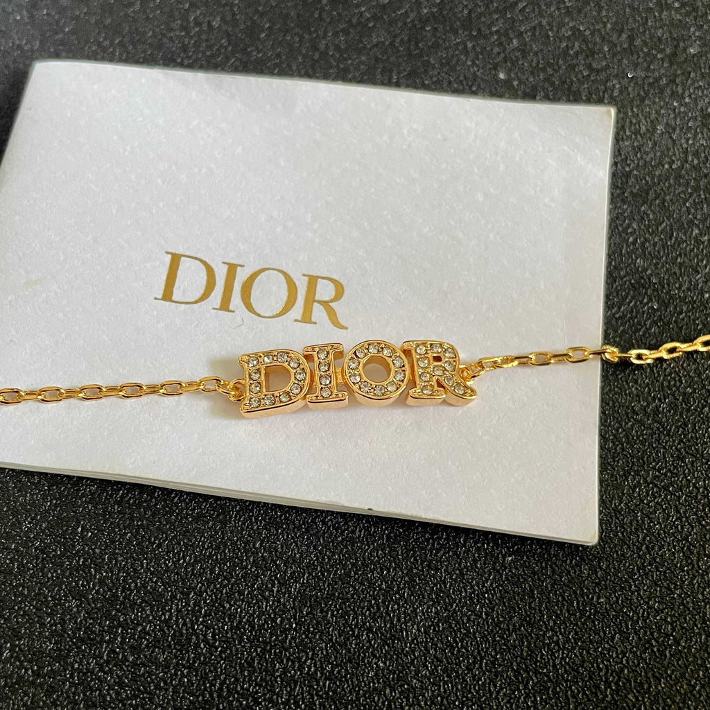 CD 26S PAVE LOGO LETTER BRACELET IN GOLD TONE METAL 631808
