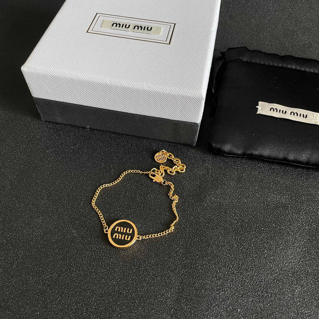 MIUMIU 26S LOGO ROUND BRACELET IN BLACK ENAMEL AND GOLD TONE METAL 631809