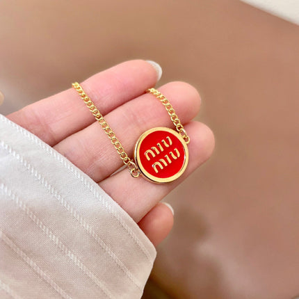 MIUMIU 26S LOGO ROUND BRACELET IN RED ENAMEL AND GOLD TONE METAL 631810