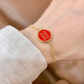 MIUMIU 26S LOGO ROUND BRACELET IN RED ENAMEL AND GOLD TONE METAL 631810