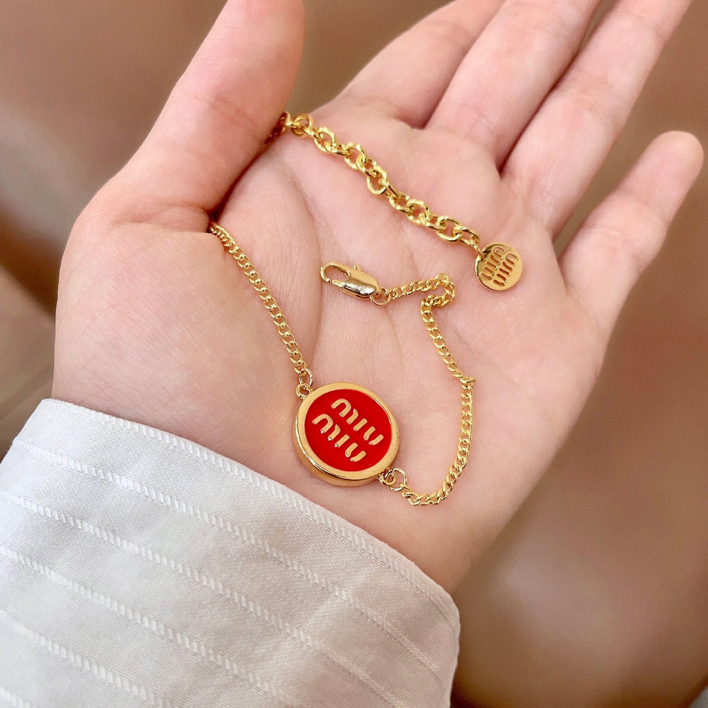 MIUMIU 26S LOGO ROUND BRACELET IN RED ENAMEL AND GOLD TONE METAL 631810
