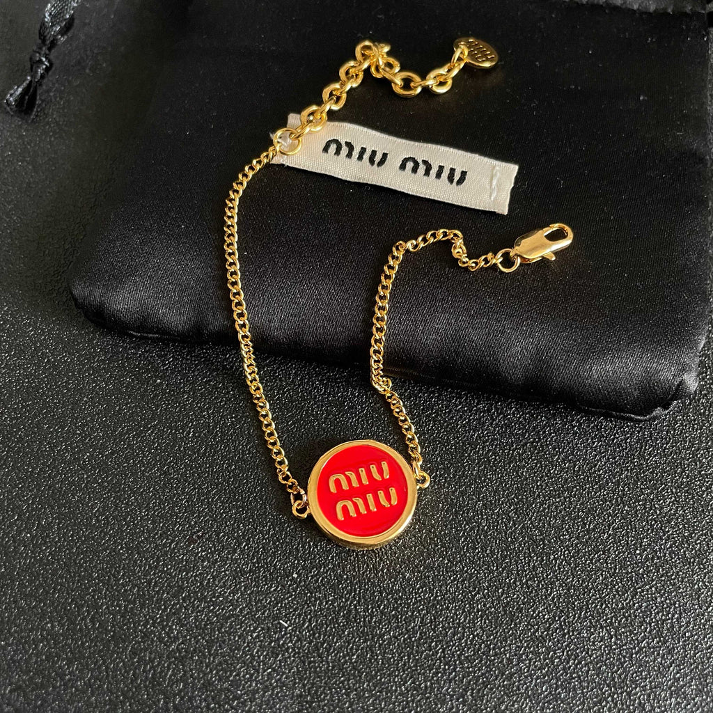 MIUMIU 26S LOGO ROUND BRACELET IN RED ENAMEL AND GOLD TONE METAL 631810