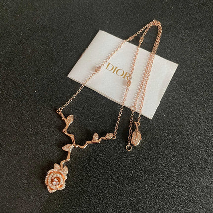 CD 26S CRYSTAL ROSE BRANCH PENDANT NECKLACE IN ROSE GOLD TONE METAL 631896