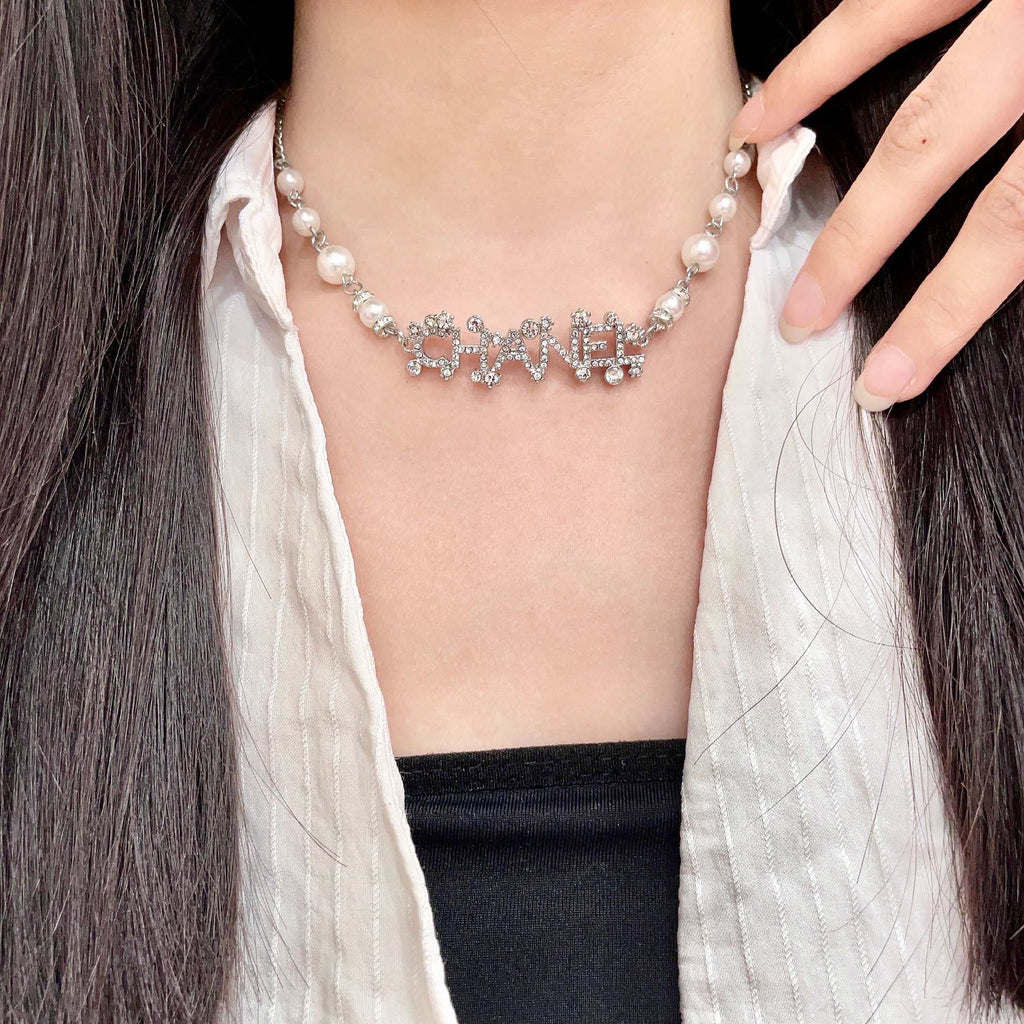 CHANEL 26S CHANEL LETTER CRYSTAL NECKLACE WITH PEARL DETAILS IN SILVER METAL 631901