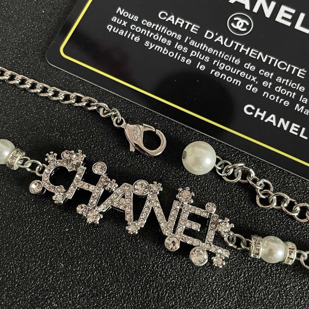 CHANEL 26S CHANEL LETTER CRYSTAL NECKLACE WITH PEARL DETAILS IN SILVER METAL 631901