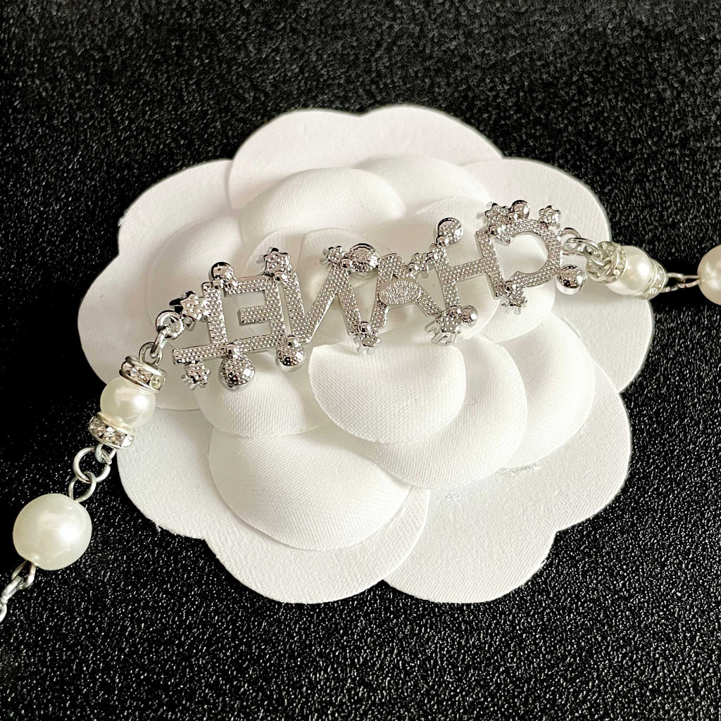 CHANEL 26S CHANEL LETTER CRYSTAL NECKLACE WITH PEARL DETAILS IN SILVER METAL 631901