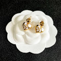 CHANEL 26S DOUBLE C HEART DROP EARRINGS WITH WHITE ENAMEL FLORAL DETAIL IN GOLD METAL 631910