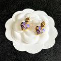 CHANEL 26S DOUBLE C HEART DROP EARRINGS WITH PURPLE ENAMEL FLORAL DETAIL IN GOLD METAL 631911