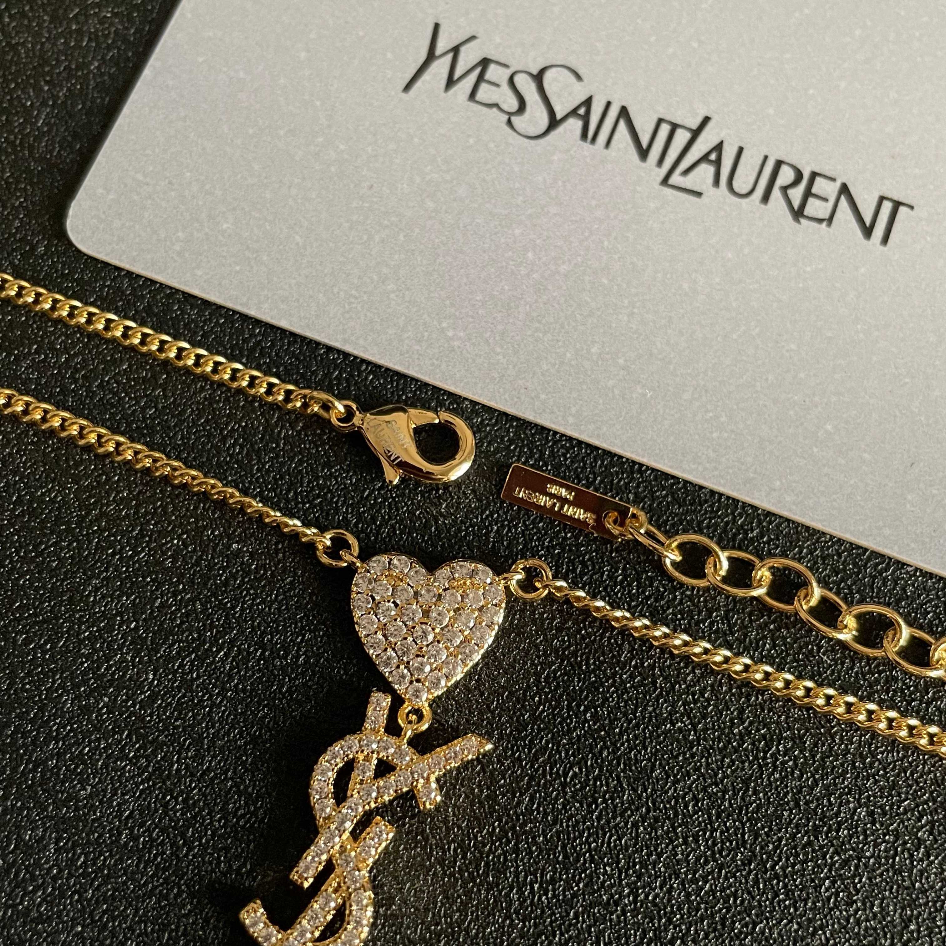 YSL 26S CRYSTAL HEART LOGO PENDANT NECKLACE IN GOLD TONE METAL 633939