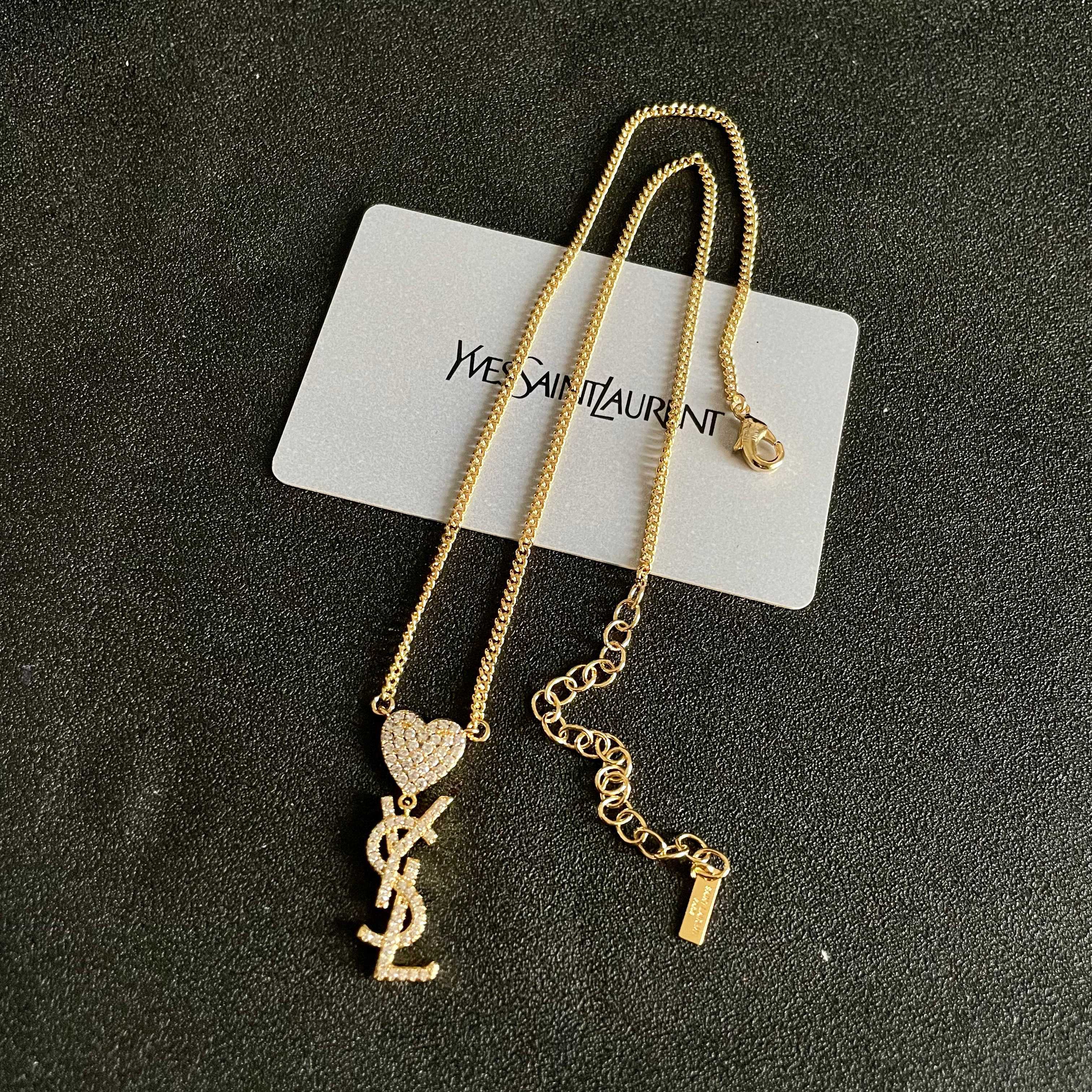 YSL 26S CRYSTAL HEART LOGO PENDANT NECKLACE IN GOLD TONE METAL 633939