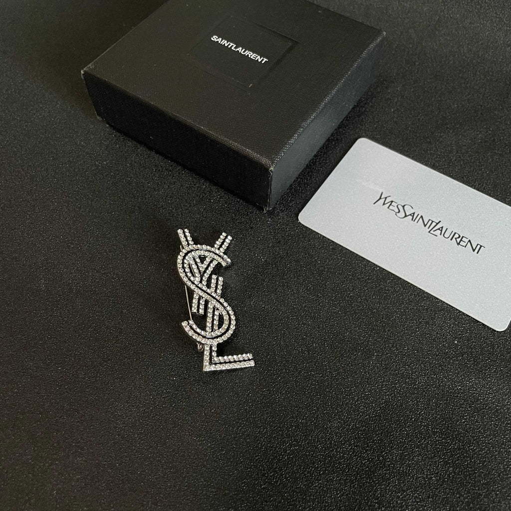 YSL 26S CRYSTAL LOGO BROOCH IN SILVER TONE METAL 634974