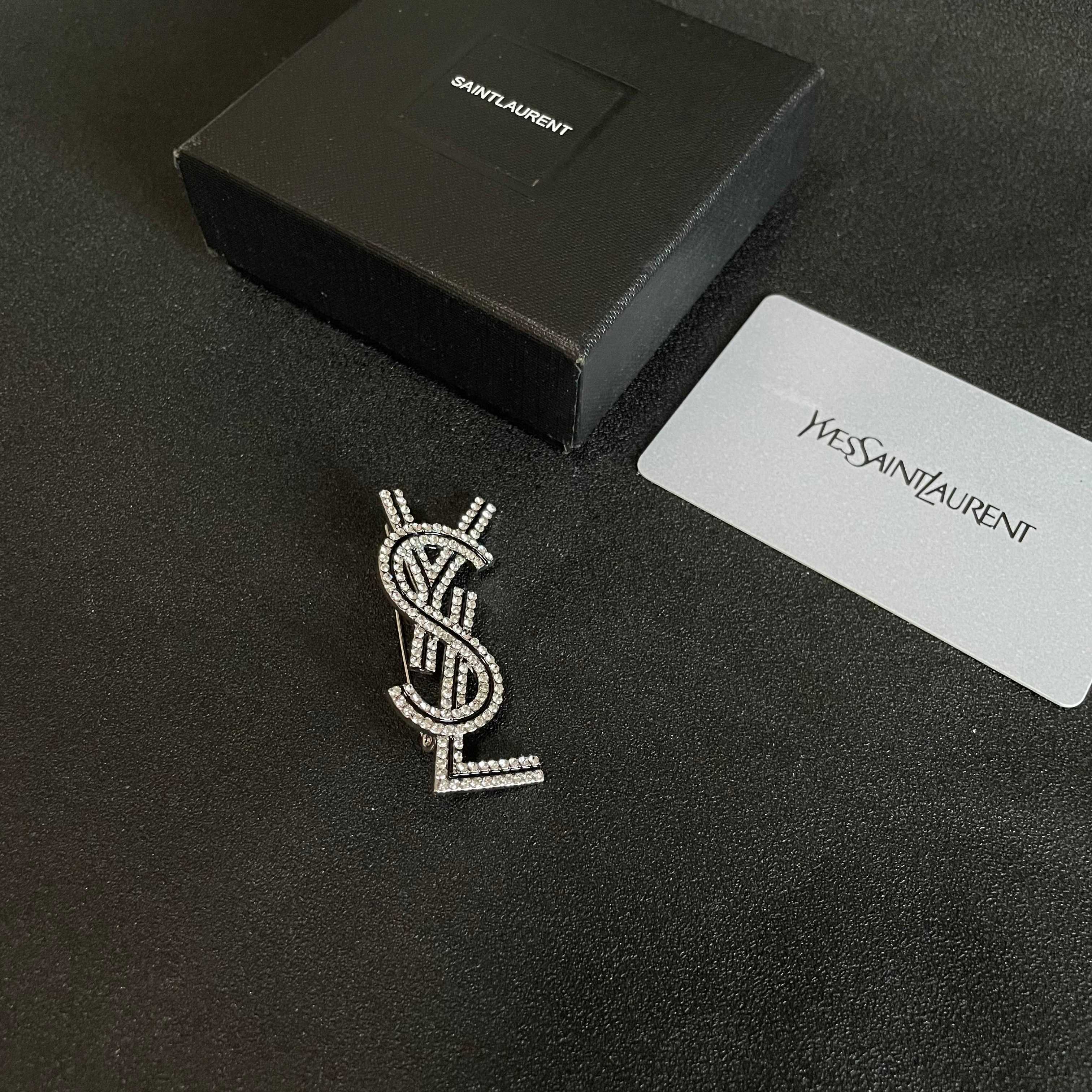 YSL 26S CRYSTAL LOGO BROOCH IN SILVER TONE METAL 634974