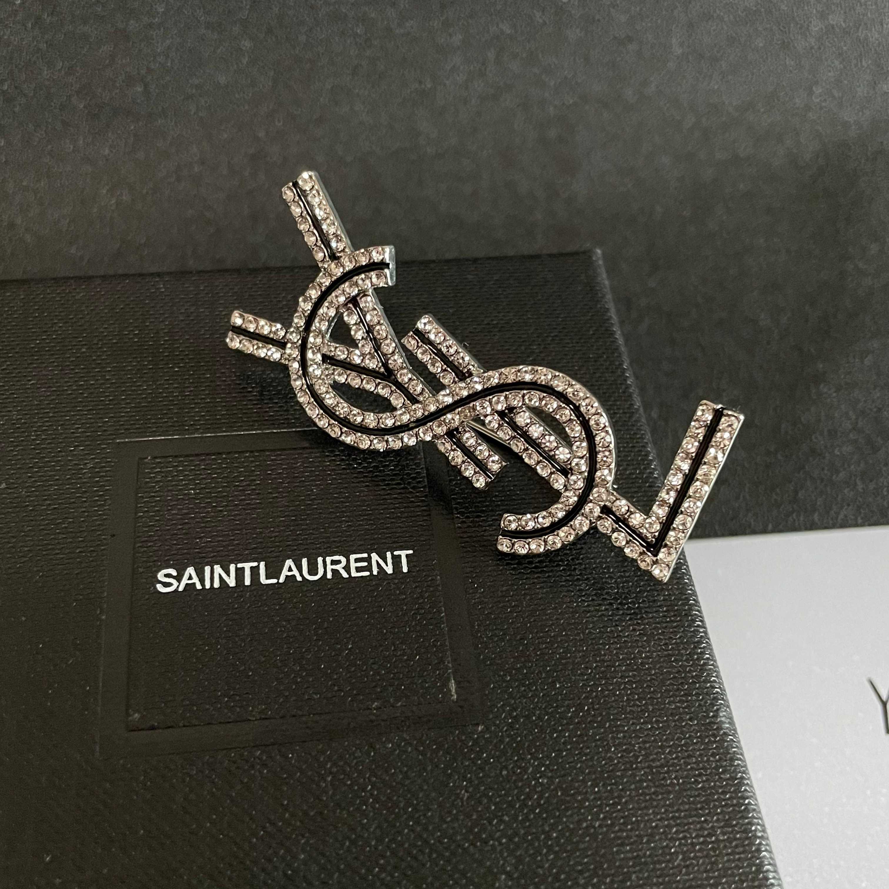 YSL 26S CRYSTAL LOGO BROOCH IN SILVER TONE METAL 634974