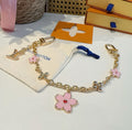 SAKURA BAG CHARM IN GOLD METAL HARDWARE