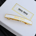 MIUMIU 26S LOGO BAR HAIR CLIP IN WHITE ENAMEL AND GOLD TONE METAL 612610