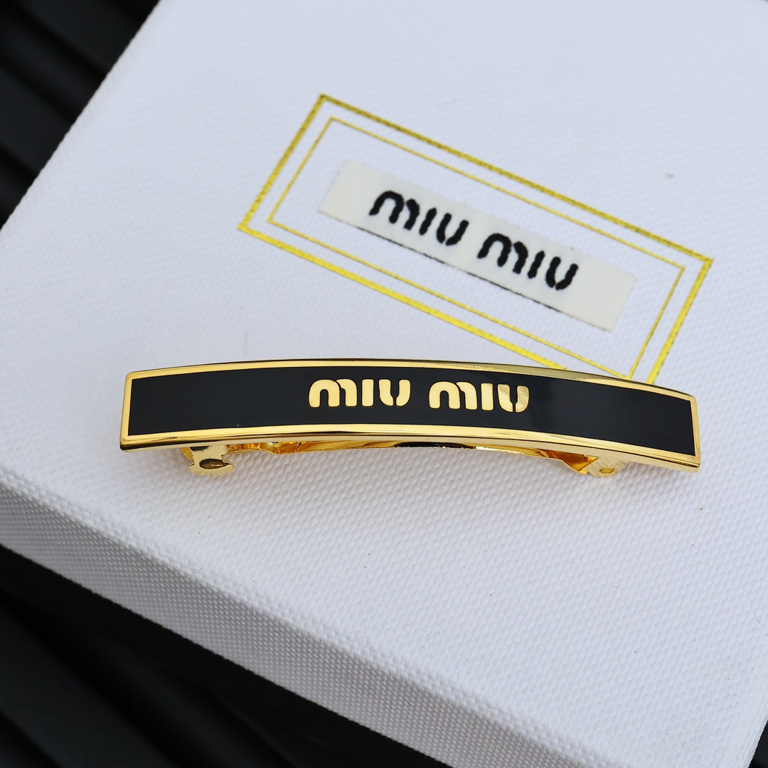 MIUMIU 26S LOGO BAR HAIR CLIP IN BLACK ENAMEL AND GOLD TONE METAL 612610