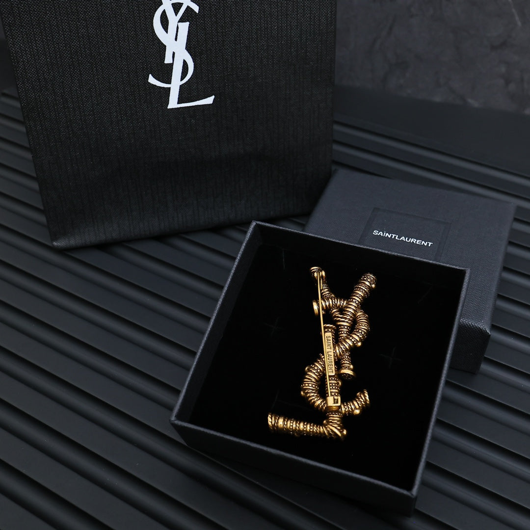 YSL 26S ORNATE TEXTURED MONOGRAM BROOCH IN ANTIQUE GOLD TONE METAL 617587