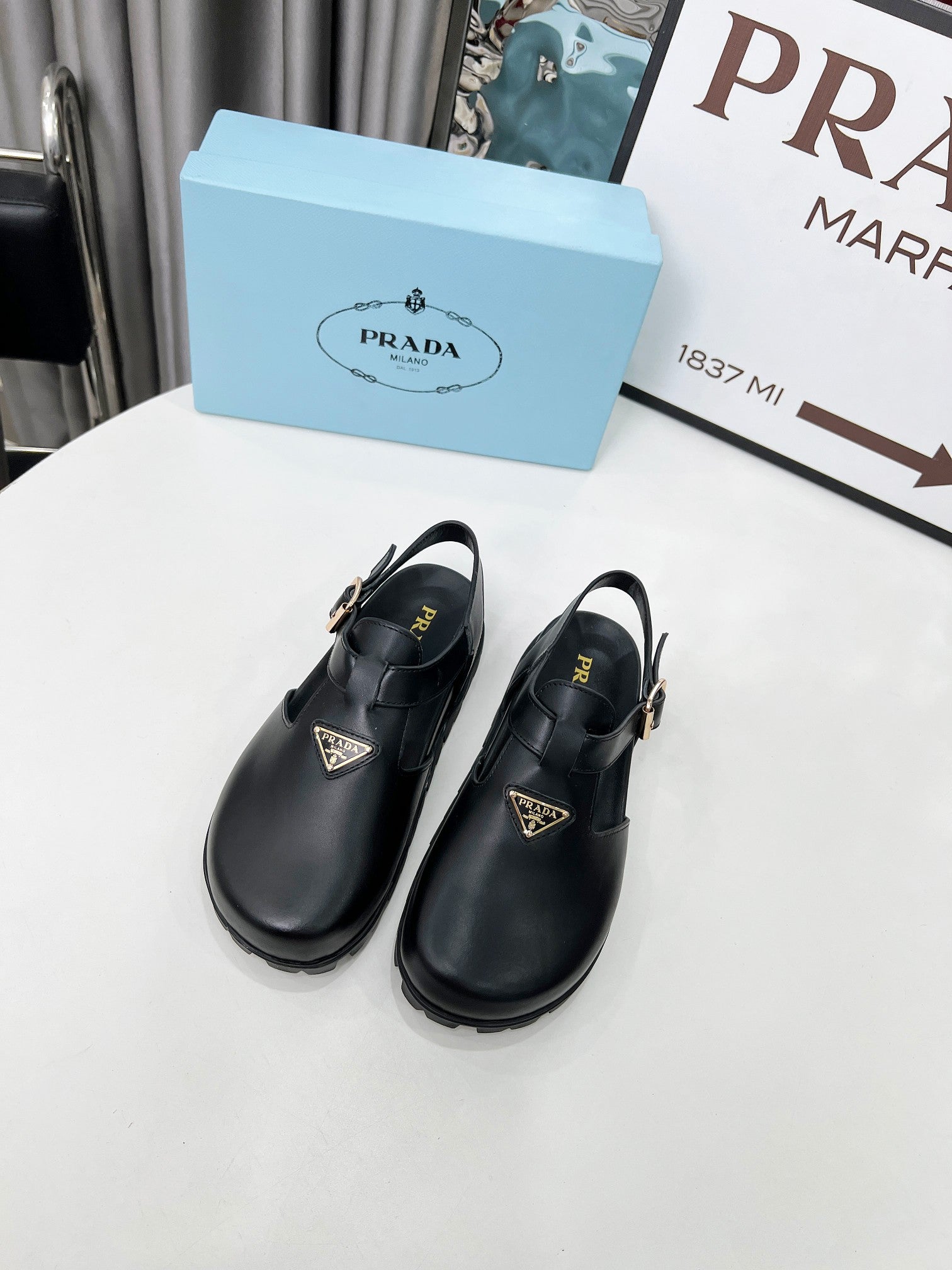PRADA 26S RUBBER LOGO CHUNKY SOLE FISHERMAN SANDALS IN BLACK CALFSKIN