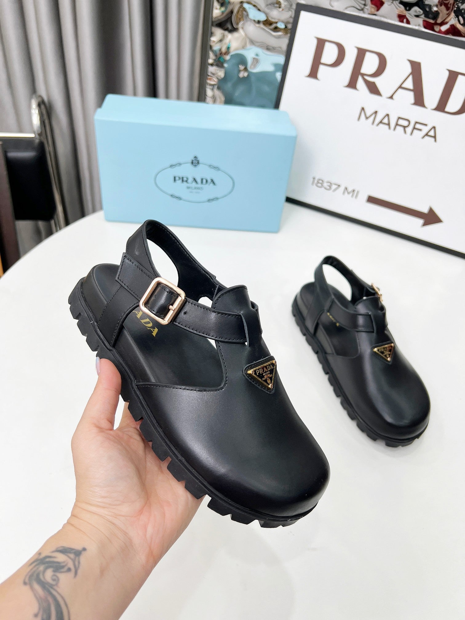 PRADA 26S RUBBER LOGO CHUNKY SOLE FISHERMAN SANDALS IN BLACK CALFSKIN