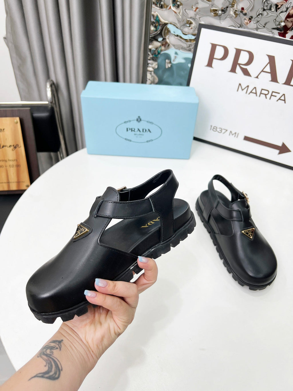 PRADA 26S RUBBER LOGO CHUNKY SOLE FISHERMAN SANDALS IN BLACK CALFSKIN