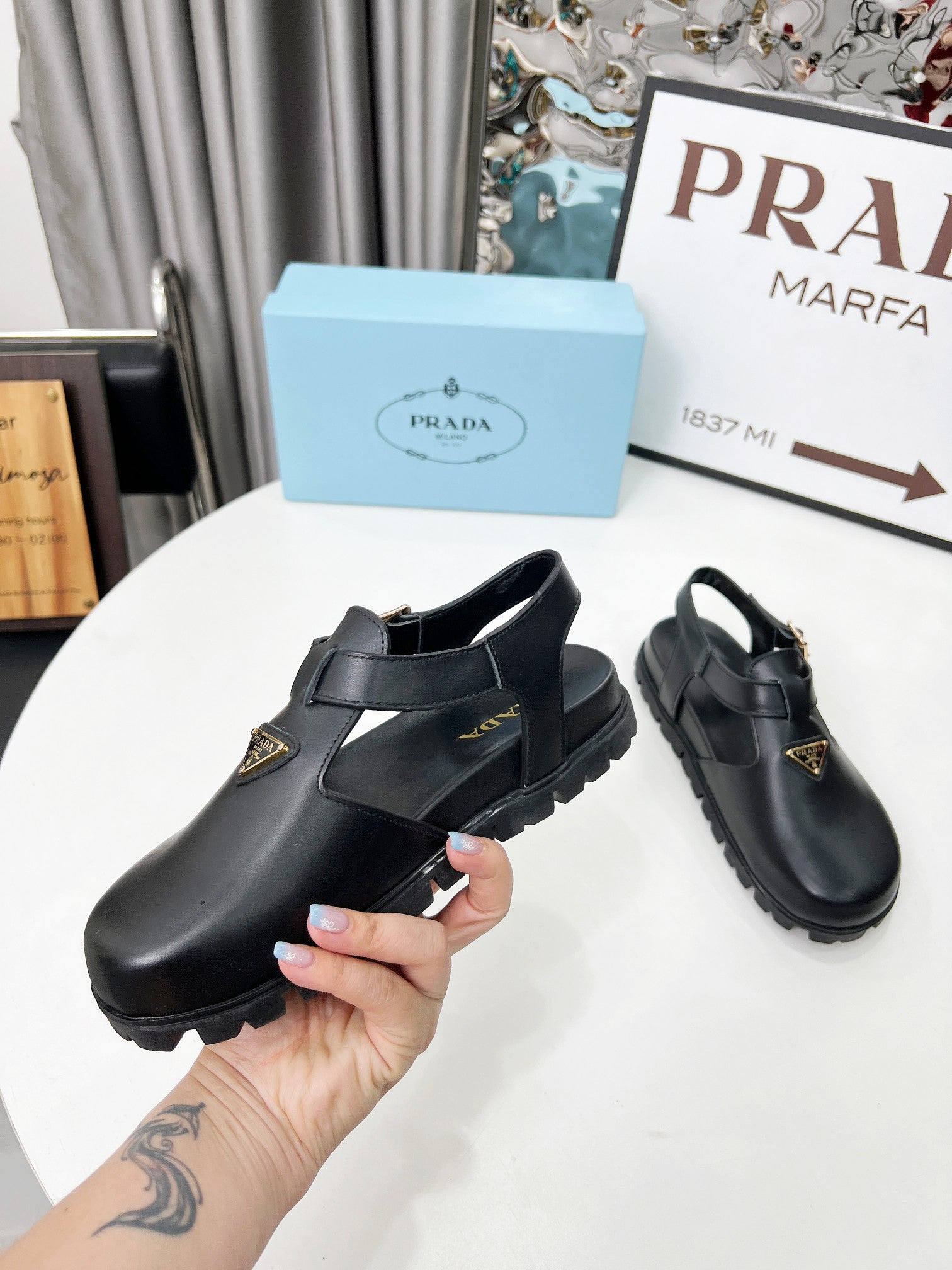 PRADA 26S RUBBER LOGO CHUNKY SOLE FISHERMAN SANDALS IN BLACK CALFSKIN