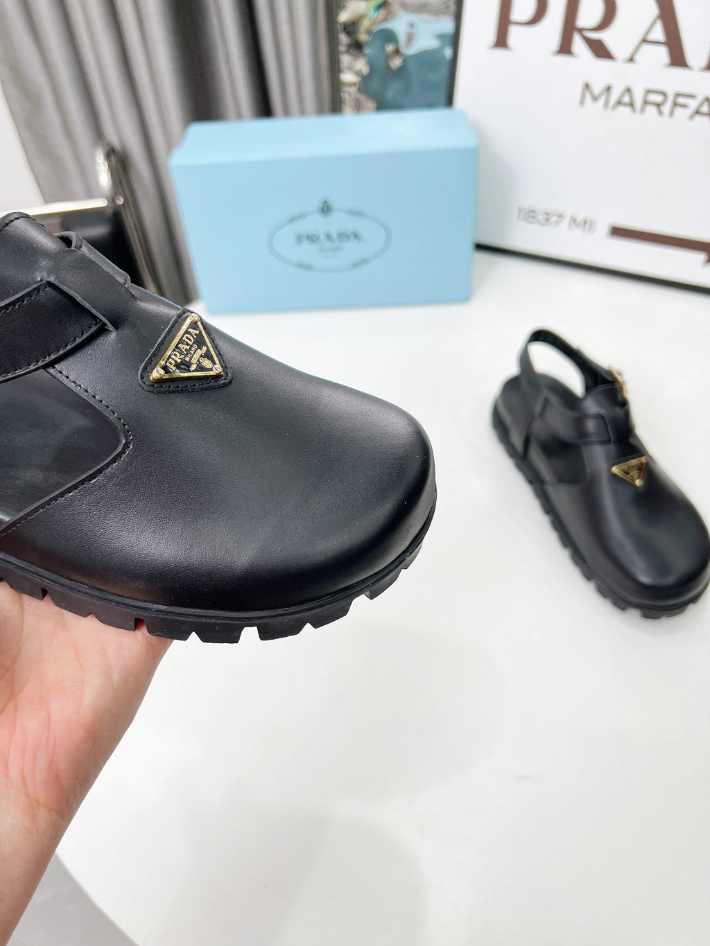 PRADA 26S RUBBER LOGO CHUNKY SOLE FISHERMAN SANDALS IN BLACK CALFSKIN