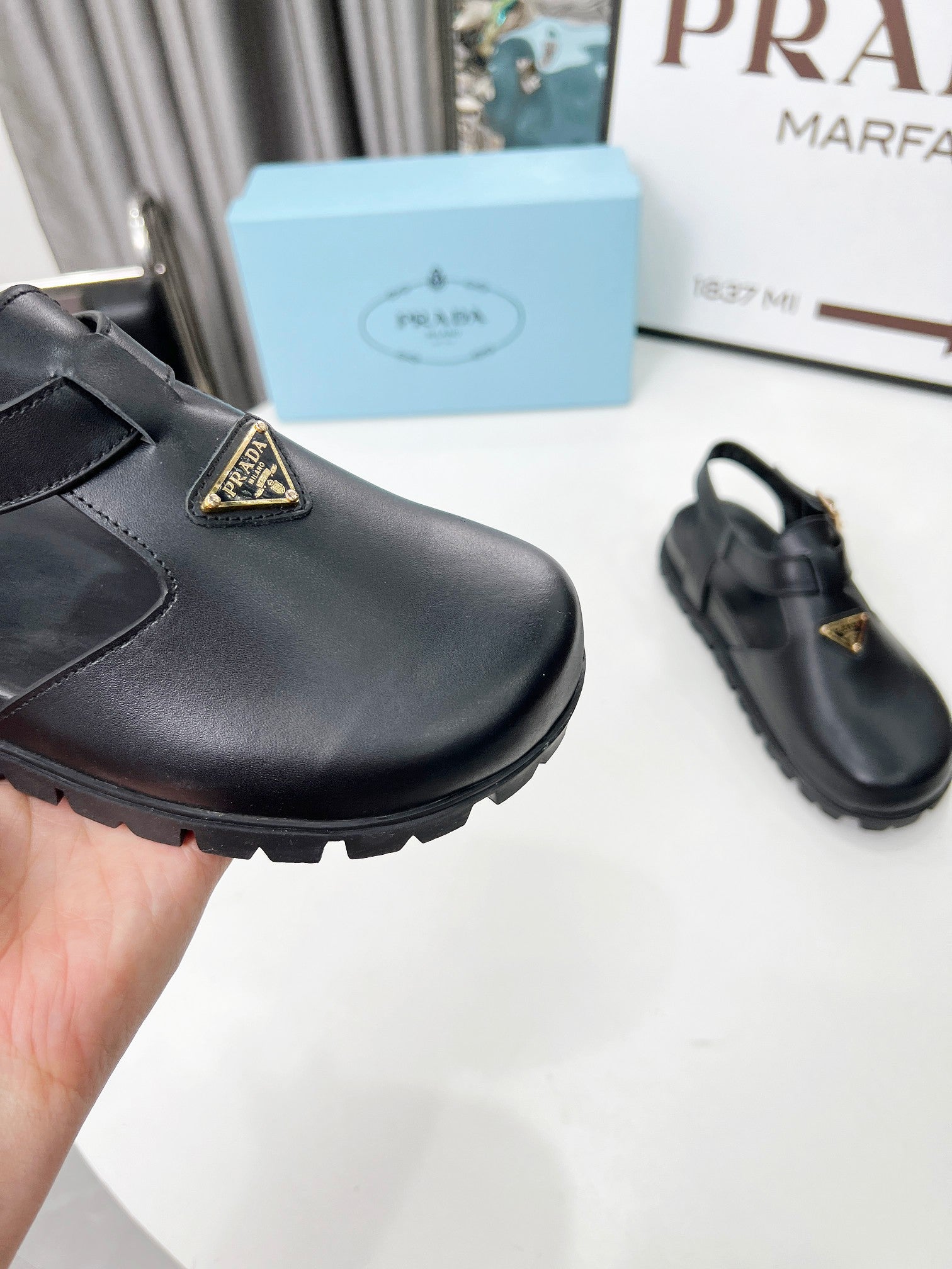 PRADA 26S RUBBER LOGO CHUNKY SOLE FISHERMAN SANDALS IN BLACK CALFSKIN