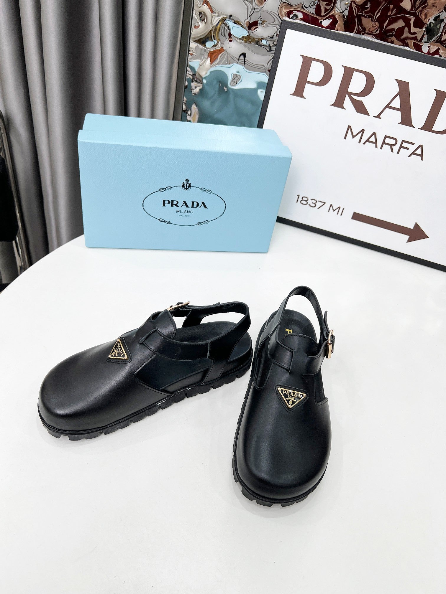 PRADA 26S RUBBER LOGO CHUNKY SOLE FISHERMAN SANDALS IN BLACK CALFSKIN