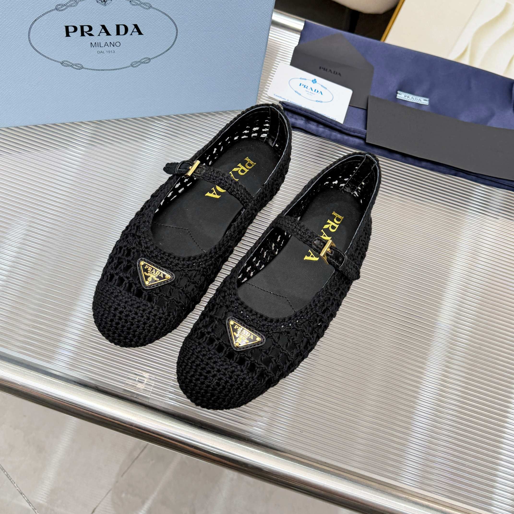 PRADA 26S MARY JANE FLATS IN BLACK WOVEN RAFFIA WITH TRIANGLE LOGO