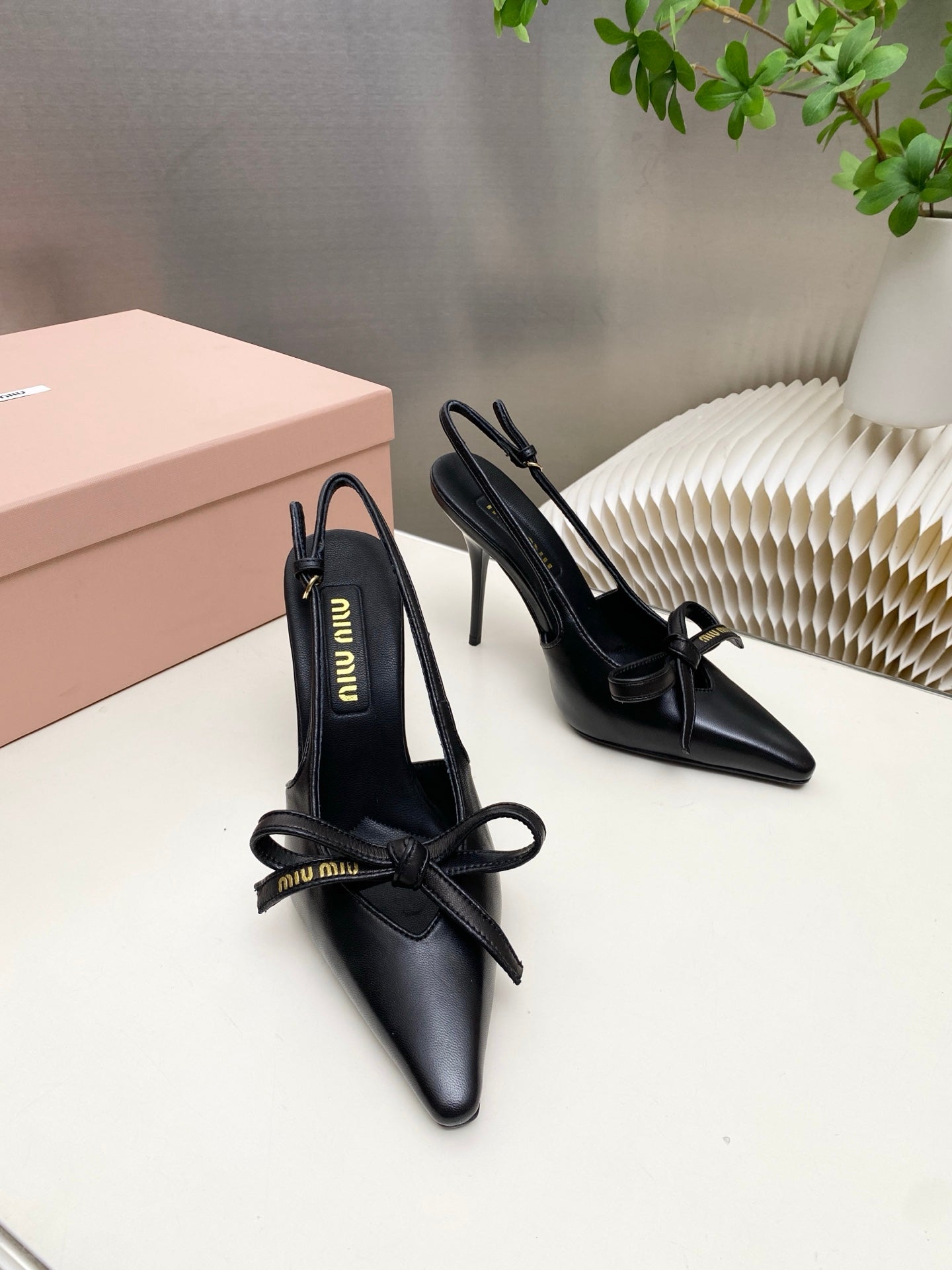 MIUMIU 26S SLINGBACK PUMPS 105MM IN BLACK CALFSKIN WITH BOW