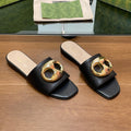 FLAT MULE IN BLACK CALFSKIN WITH GOLD HARDWARE