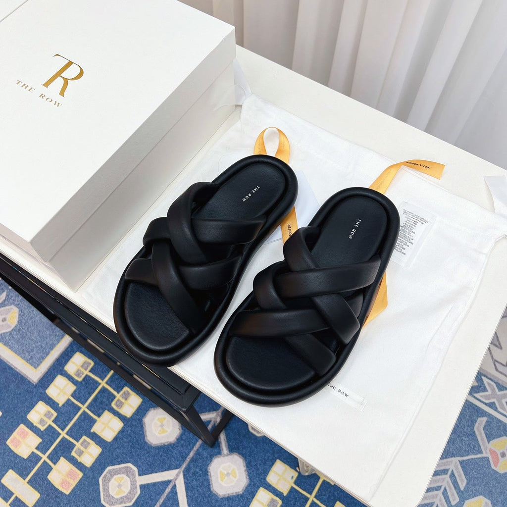 THE ROW 26S CROSSED PADDED SLIDES IN BLACK CALFSKIN
