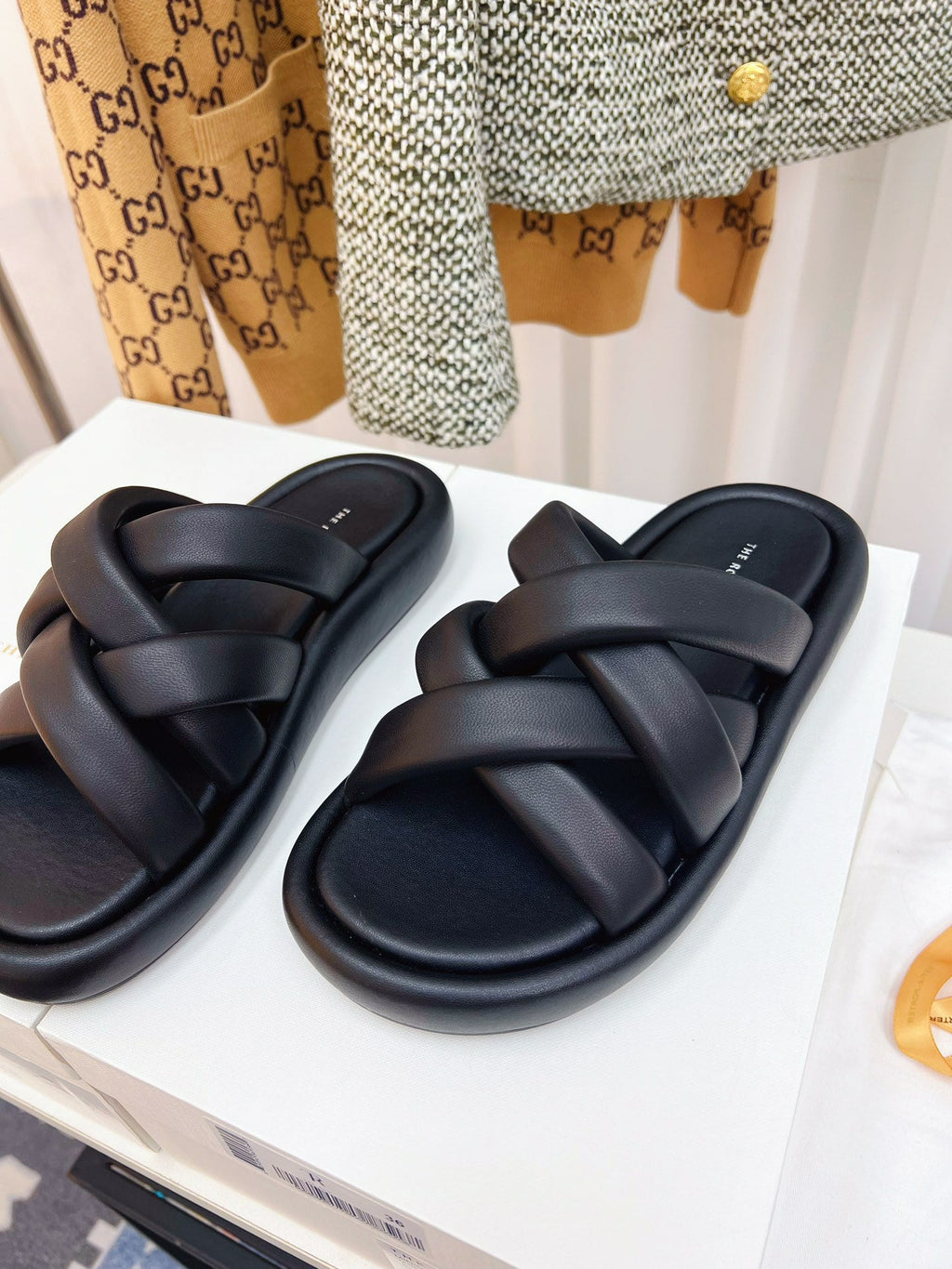THE ROW 26S CROSSED PADDED SLIDES IN BLACK CALFSKIN