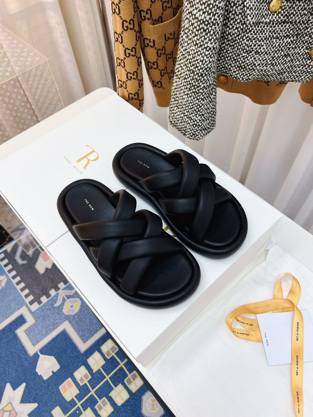 THE ROW 26S CROSSED PADDED SLIDES IN BLACK CALFSKIN