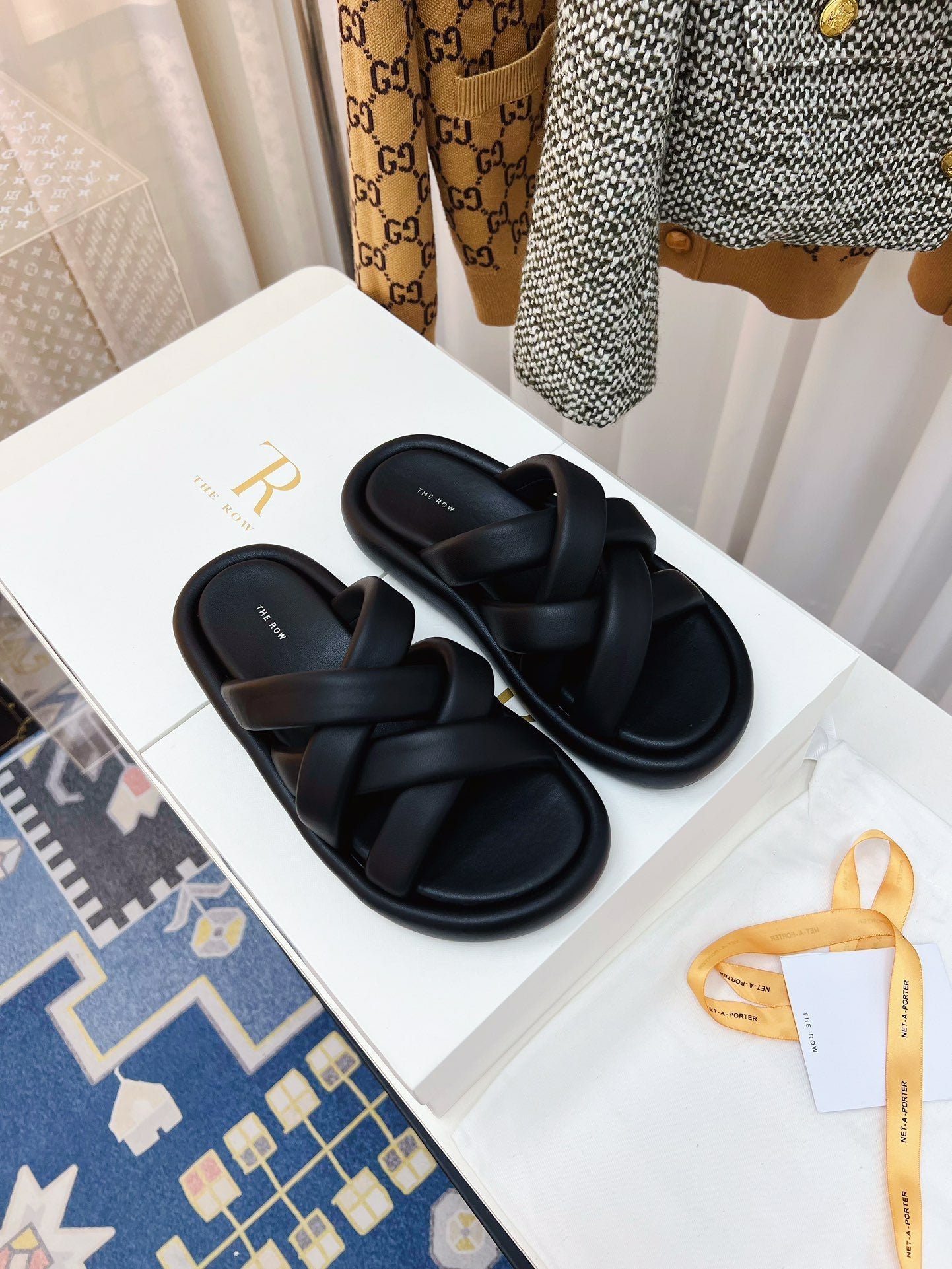 THE ROW 26S CROSSED PADDED SLIDES IN BLACK CALFSKIN