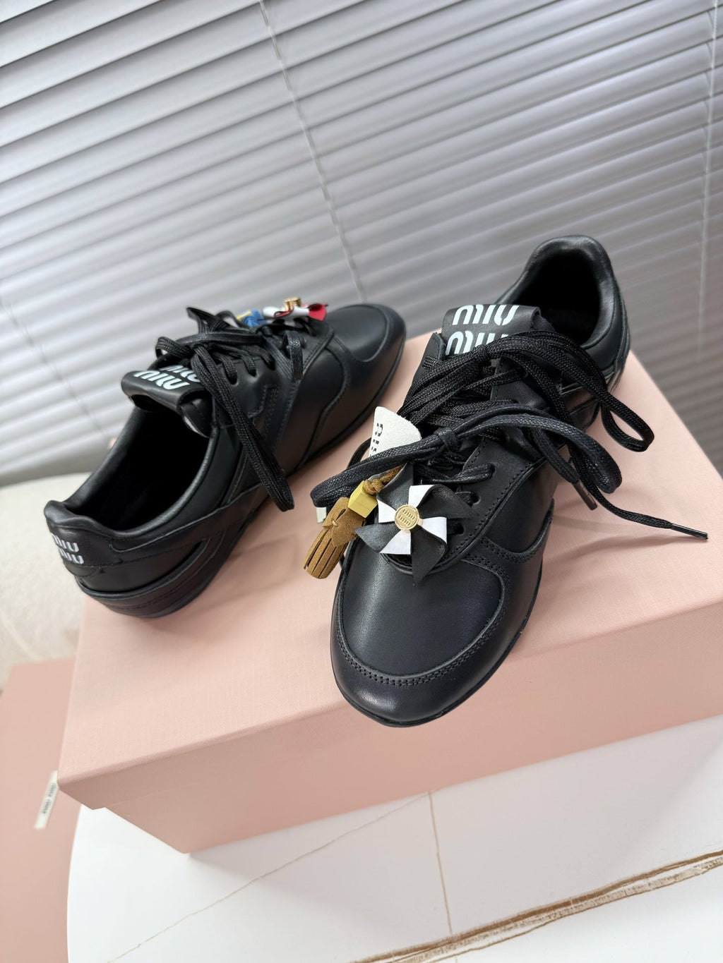 MIUMIU 26S GYMNASIUM SNEAKER IN BLACK CALFSKIN WITH GOLD BUCKLED STRAP