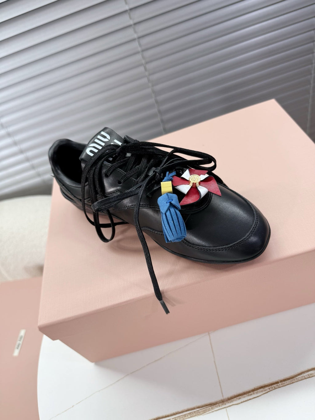 MIUMIU 26S GYMNASIUM SNEAKER IN BLACK CALFSKIN WITH GOLD BUCKLED STRAP