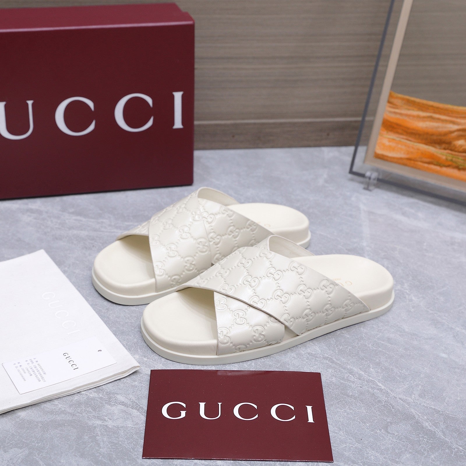 GUCCI 26S CROSSOVER SANDALS IN WHITE GG EMBOSSED CALFSKIN